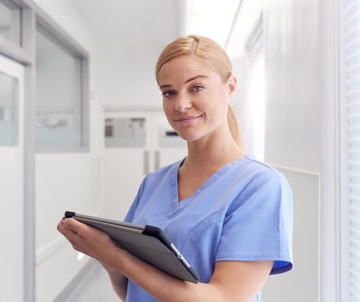portrait-of-smiling-female-doctor-wearing-scrubs-EYSJKTB-1.jpg